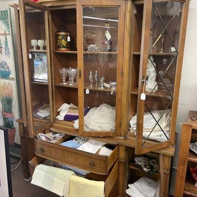 Vintage china cabinet filled with glass blown items, linen, sterling items