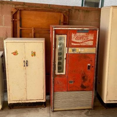 Vintage Coke machine.  Metal storage cabinets.