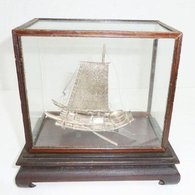 Silver ship in glass case
