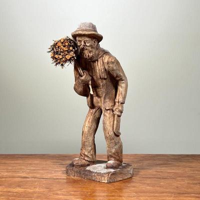 HAND CARVED WOODEN STATUE | Small, hand-carved wooden statue, depicting an elderly man carrying a bundle of sticks. - l. 3 x w. 3 x h....