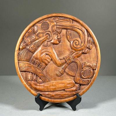 CARVED PLAQUE | Hand-carved, round, wooden plaque depicting a seated Mayan figure precisely carved in high relief. - dia. 13.25 in 