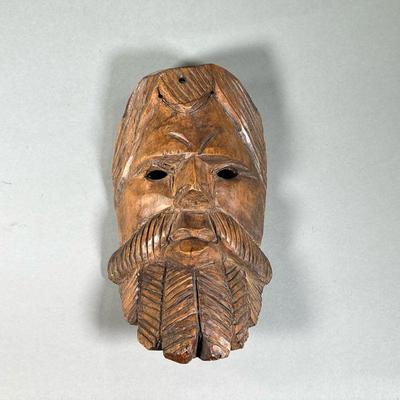 HAND-CARVED GUATEMALAN MASK | Hand-carved wooden mask in the shape of a serious man with a large coiled beard. - l. 6 x w. 4 x h. 12 in 