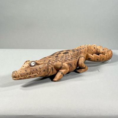 CARVED CROCODILE STATUE | Hand carved and painted crocodile statue with seashell eyes. - l. 21 x w. 5.5 x h. 4 in 