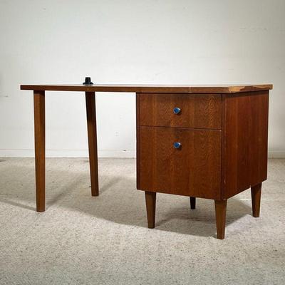 MID CENTURY WRITING DESK | Slender mid-century wooden writing desk with two drawers on the right-hand side featuring blue enameled metal...
