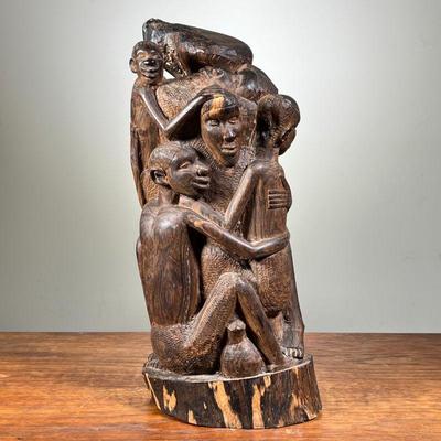 LARGE AFRICAN CARVED SCULPTURE | African wooden carving. Depicts large family or group of people embracing. - l. 6.5 x w. 5.5 x h. 15 in 