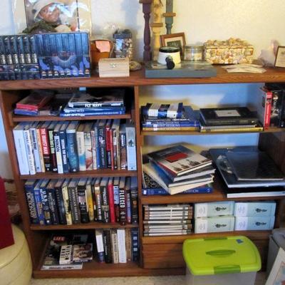 Wooden bookshelf storage is full of great books! Military history collector books, novels & more.