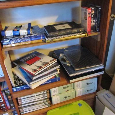 Wooden bookshelf storage is full of great books! Military history collector books, novels & more.