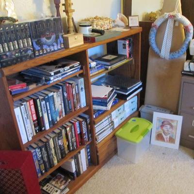 Wooden bookshelf storage is full of great books! Military history collector books, novels & more.