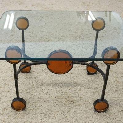 1250	MODERN GLASS TOP LAMP TABLE W/WROUGHT IRON BASE HAVING AMBER GLASS BULLSEYE, APPROXIMATELY 28 IN X 22 IN X 17 IN
