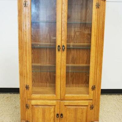 1170	SOLID OAK 4 DOOR CURIO CABINET, 2 GLASS OVER 2 SOLID, HAS HALF REEDED COLUMN SIDES, INTERIOR LIGHTS & GLASS SHELVES, APPROXIMATELY...