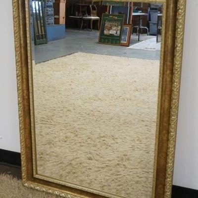 1267	HANGING BEVELED EDGE MIRROR IN GILT FRAME, APPROXIMATELY 30 IN X 42 IN
