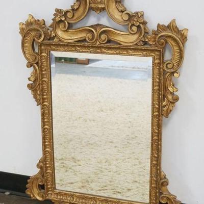 1268	HANGING BEVELED EDGE MIRROR IN ORNATE PIERCED GILT FINISHED FRAME, APPROXIMATELY 23 IN X 39 IN
