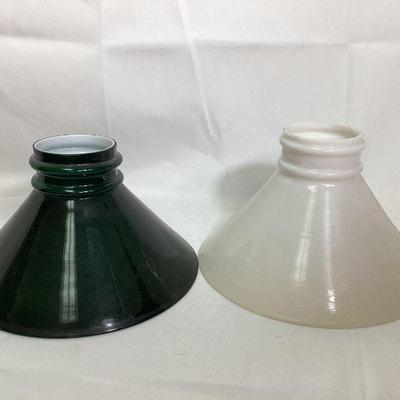 JIFI705 Cased Glass Lamp Shades	Two glass lamp shades: Â one is white the other dark green.
