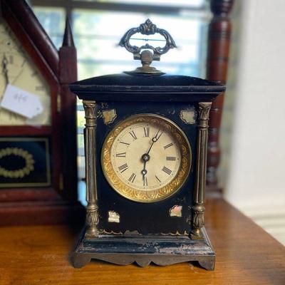 Antique cast iron clock with mother of pearl inlays on the corners and ornate handle. Estate sale price: $95