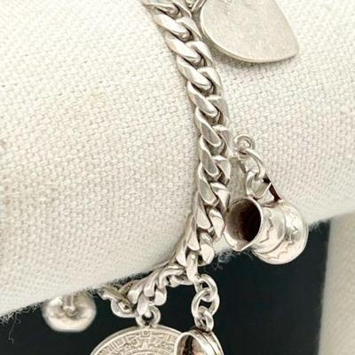 925 Sterling Silver Mexican Charm Bracelet & Charms
38 grams and approximately 7.25 inches long, as shown. The bracelet is stamped,...