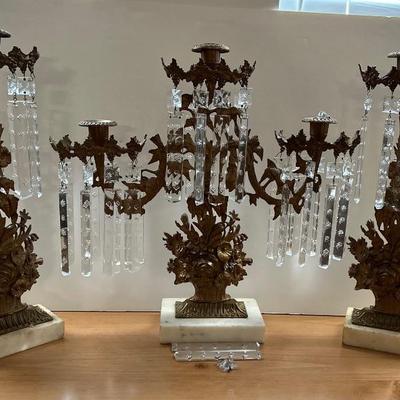 A 19th century three piece Bronze and Marble Girandole set.  Cast flower basket stems with on White Marble bases includes one three...
