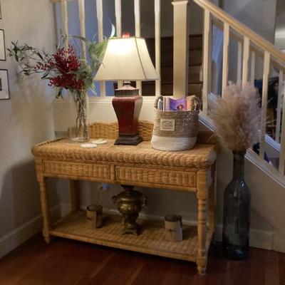 Wicker storage table with lamps and decor