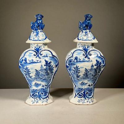 (2pc) PAIR CHINOISERIE URNS | Blue and white pottery lidded jars/urns with blue underglaze, likely Dutch, decorated with landscape with...