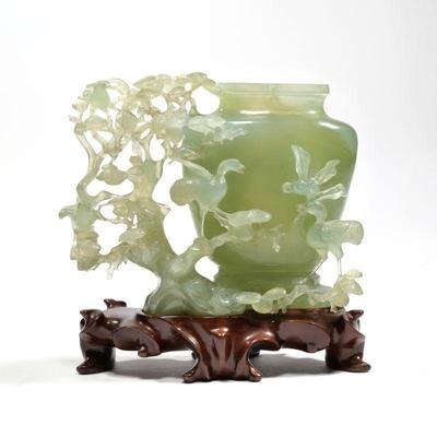 RETICULATED CARVED JADE VESSEL | On a conforming carved wood stand - l. 7 x w. 3 x h. 5.5 in. (Jade only)
