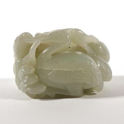 CHINESE CELADON JADE FIGURAL GROUP | Carved pale celadon jade figural group showing a deer and stork among flowering branches; 128g - l....