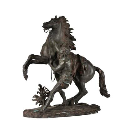 CLASSICAL HORSE SCULPTURE | Patinated metal, showing a man taming a horse; no apparent signature - l. 22 x w. 10 x h. 22.5 in.