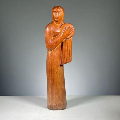 ATTRIB. LINTON (20TH CENTURY) | Female figure with drum. Modernist carving depicting a woman holding a drum - h. 19.5 in.
