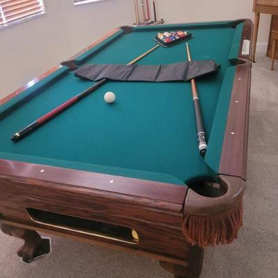 Very nice pool table with a new table cover, cue sticks, rack and cue holder