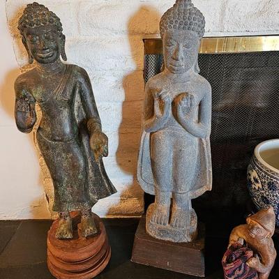 Large standing hand carved stone Buddha sculptures.