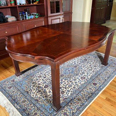 WINTERTHUR SHAPED TOP DINING TABLE | With center fields of reverse diamond matched flaming swirl-off-crotch-mahogany veneers, top...