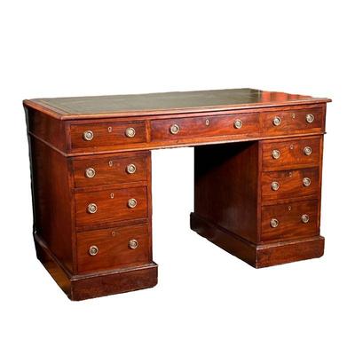 ENGLISH MAHOGANY PEDESTAL WRITING DESK | Oblong top with gilt-tooled green leather writing surface and molded edge projecting over 3...