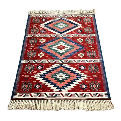 ANATOLIAN WOOL KILIM RUG | Flat woven Killiam rug with three medallions on a red ground and other geometric devices. - l. 64 x w. 43 in 