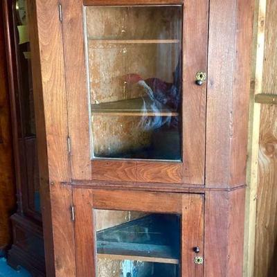 JIFI108 Aged Antique Corner Cabinet	Rustic, corner cupboard with original glass, in doors. Square nails. Looks to have a repair on one of...
