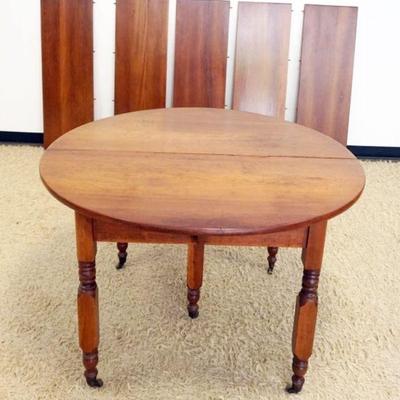 1259	COUNTRY CHERRY 46 IN ROUND TABLE W/5-15 1/4 IN PINE STAINED CHERRY TABLE LEAVES, APPROXIMATELY 30 IN HIGH
