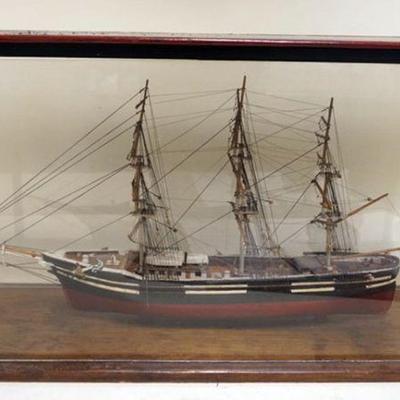 1129	WOOD SHIPS MODEL UNDER GLASS, APPROXIMATELY 7 1/2 IN X 23 IN X 13 IN HIGH
