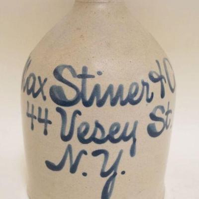 1073	BLUE SCRIPT DECORATED STONEWARE JUG, MAX STINER & CO NY, CHIP ON TOP SPOUT, APPROXIMATELY 9 1/4 IN HIGH
