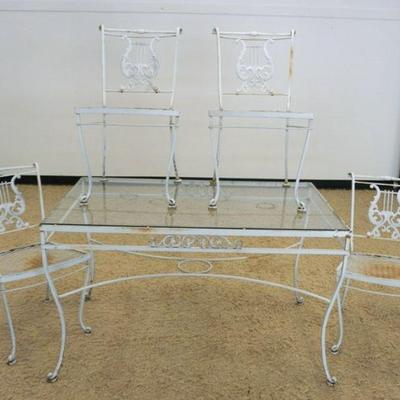 1033	CAST METAL PATIO SET, CHAIRS HAVING LYRE HARP SHAPED BACKS W/GLASS TOP TABLE, TABLE APPROXIMATELY 16 IN X 31 IN X 30 IN HIGH
