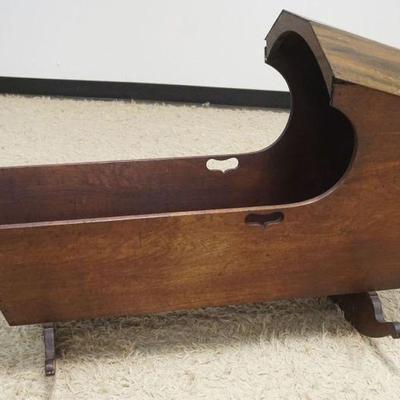 1295A	ANTIQUE WALNUT HOODED CRADLE W/FINE DOVETAILING, LOSS TO ONE SIDE OF ROCKER, APROXIMATELY 26 IN X 43 IN X 30 IN HIGH
