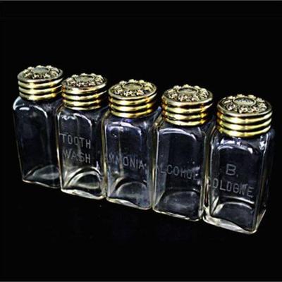 Lot 043   
Victorian Vanity Set Glass Bottles with Repousse Sterling Silver Covers