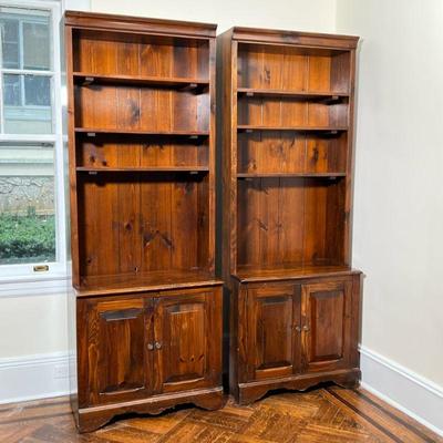 (2PC) PAIR PLYMWOOD SUGARHILL PINE BOOKCASES | Each with three adjustable open shelves over double cabinet doors. - l. 30 x w. 16.25 x h....