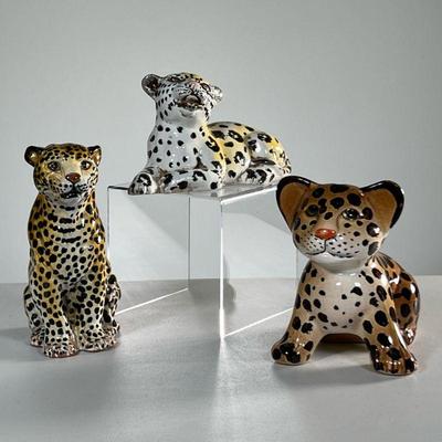 (3PC) CERAMIC LEOPARDS | Including one marked on the bottom, one in a seated upright position, and one leopard piggy bank. - l. 5 x w....