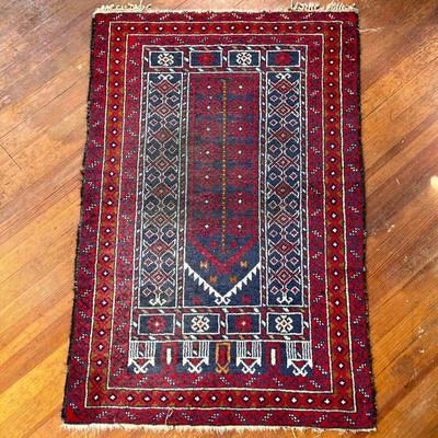PERSIAN STYLE GEOMETRIC RUG | Having deep blue background in center with geometric shapes and border against red background. - l. 51.5 x...