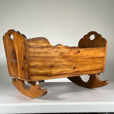 ANTIQUE WOODEN ROCKING CRIB | Small carved wooden crib with curved rocking legs. - l. 24.25 x w. 17 x h. 15.5 in 