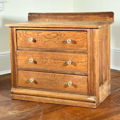 COUNTRY PINE CHEST | Small chest of drawers or side table having three drawers with carved fronts and double glass pulls. - l. 31.5 x w....