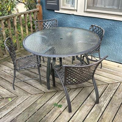 (5PC) BROWN JORDAN PATIO SET | Including a round glass top table, 4 aluminum and woven outdoor chairs- 2 of them being armchairs; plus an...