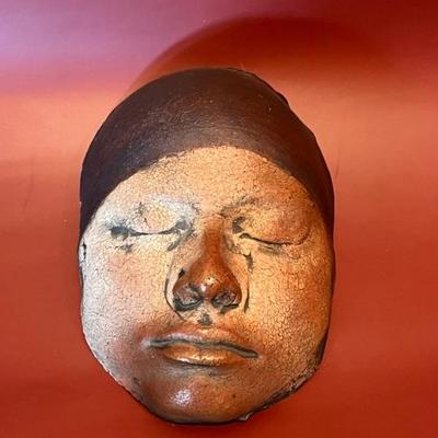 ceramic mask, human face, signed Mya--that's all I know about, but it is creepy and cool!