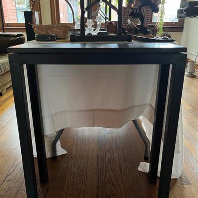 small console table with metal base and granite top