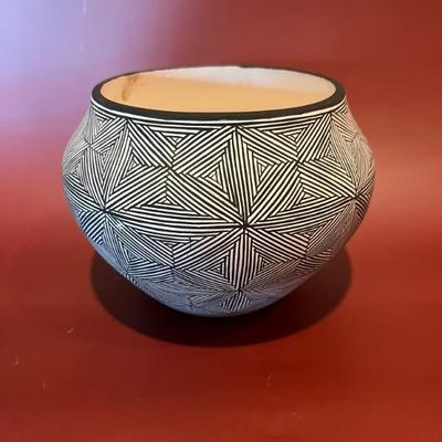 New Mexican pottery bowl, signed R. Poncho, with black and geometric designs 