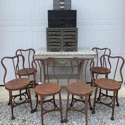 Early Metal banjo back pub chairs, vintage smoke gray workbench, assorted antique to vintage multi drawer cabinets. 