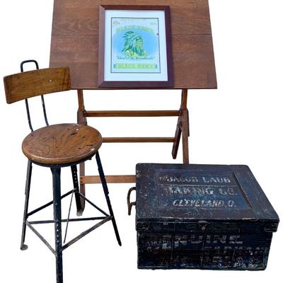 Mid Century drafting table, early industrial stool, c1938 embossed metal Black Hawk Cigar sign, Early Cleveland Ohio Bakery Crate. 