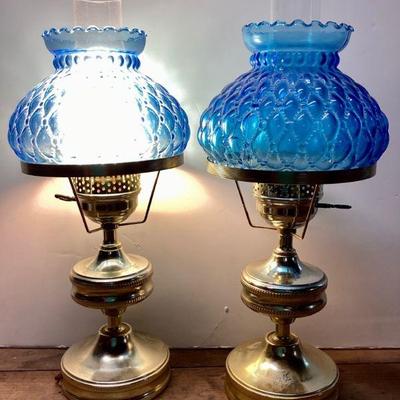 JUCR904 Diamond Quilted Glass Shaded Lamps	Pair of electric lamps with clear glass hurricanes and blue glass shades. 1 lamp works. Â...